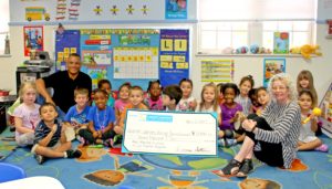 Grant recipient Wesley House Family Services: Jeremy Wilkerson (back row, left) and CFFK Grant Committee Chair Rita Linder (front, right) with kids from the Inez Martin Childcare Center.