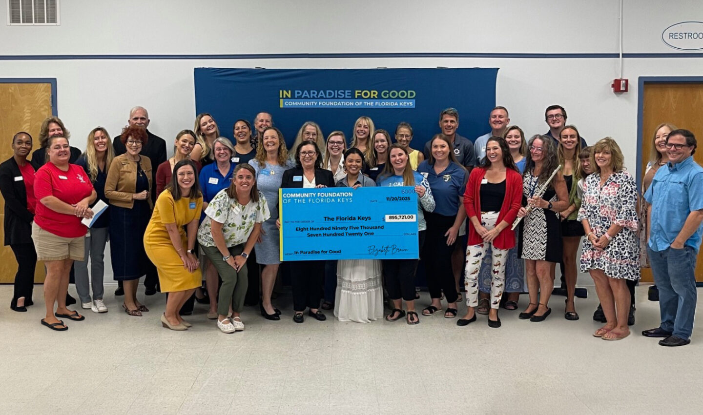 Group of people with giant check