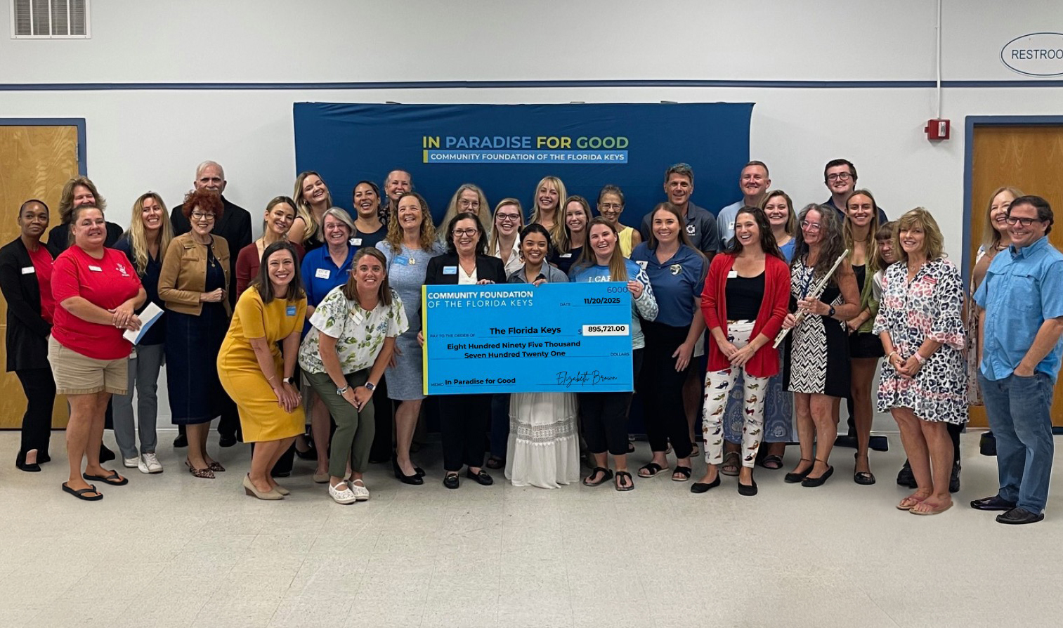 Group of people with giant check